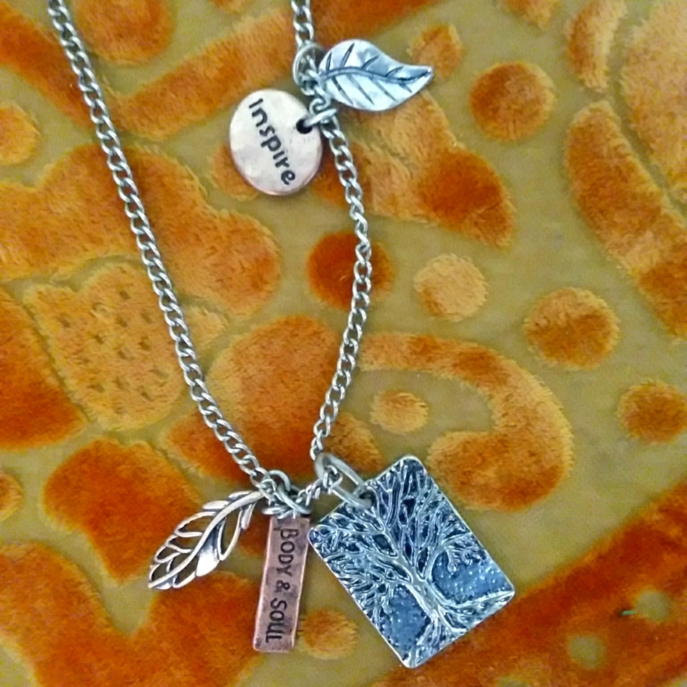 Inspire necklace. Set in silver tone with copper.